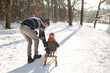 © Frank van Delft/Westend61 - Father teaching sledding to son on snow during sunny day
