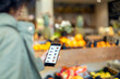 © Emma Innocenti/Westend61 - Woman buying groceries through mobile application in supermarket