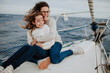 © Gala Mart√≠nez L√≥pez/Westend61 - Cheerful mother embracing daughter while traveling on sailboat