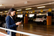 © Francesco Morandini/Westend61 - Female professional using smart phone while standing in parking lot