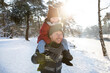 © Frank van Delft/Westend61 - Father carrying son on shoulder in winter during sunny day