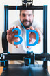 © Josu Acosta/Westend61 - Male technician holding 3D printed text through machinery