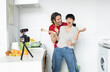© Jose Carlos Ichiro/Westend61 - Playful couple cooking food while vlogging in kitchen at home