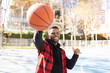 © Jose Carlos Ichiro/Westend61 - Cheerful man showing shaka sign while playing basketball on sunny day