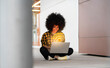 © Jose Carlos Ichiro/Westend61 - Afro woman using laptop with digitally generated WIFI logo