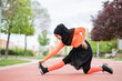 © Jose Carlos Ichiro/Westend61 - Arab woman stretching in public park