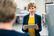 © Joseffson/Westend61 - Mature manager holding digital tablet while standing with colleague in workshop