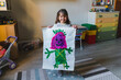 © Giorgio Magini/Westend61 - Smiling girl holding drawing at home