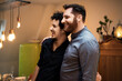 © Malte Jager/Westend61 - Happy male friends looking away while smiling at home