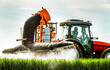 © oticki/Westend61 - Farmer spraying herbicide on wheat crop while sitting in tractor