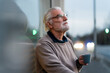 © Robijn Page/Westend61 - Contemplating senior man with coffee cup outside cafe at street