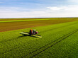 © oticki/Westend61 - Crop sprayer sprinkling fungicide on wheat field during sunny day