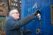 © Pete Muller/Westend61 - Caucasian male technician with keys opening door of workshop