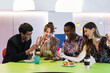 © NOVELLIMAGE/Westend61 - Multi ethnic male and female colleagues enjoying breakfast in office