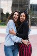 © NOVELLIMAGE/Westend61 - Smiling female friends hugging each other while standing outdoors