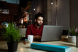 © Rafa Cortes/Westend61 - Mid adult male freelancer with coffee cup working on laptop in cafe