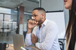 © SERGIO NIEVAS/Westend61 - Thoughtful businessman looking away while sitting by female colleague in coworking office