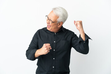 Middle age Brazilian man isolated on white background celebrating a victory