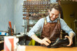 © Vladimir Godnik/Westend61 - Male shoemaker polishing black shoe at workshop
