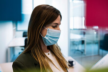 Businesswoman Wearing Protective Face Mask At Office During COVID-19