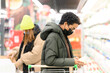 © Katharina und Ekaterina/Westend61 - Female friends wearing protective face mask while buying groceries in supermarket during COVID-19