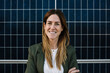 © Xavier Lorenzo/Westend61 - Smiling female entrepreneur in smart casual standing by wall