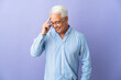 © luismolinero - Middle age Brazilian man isolated on purple background laughing