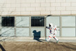 © Eugenio Marongiu/Westend61 - Female astronaut walking at building in city during sunny day