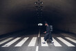 © Eugenio Marongiu/Westend61 - Young man with backpack walking on zebra crossing at underpass