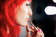© Manu Reyes/Westend61 - Beautiful make-up artist applying lipstick at studio