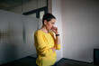 © Oxana Guryanova/Westend61 - Businesswoman thinking while standing in office