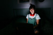 © Tania Cervian/Westend61 - Beautiful woman using laptop in darkroom