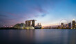 © Alex Holland/Westend61 - Singapore, Long exposure of Marina Bay at dusk with Marina Bay Sands hotel and Singapore Flyer in background
