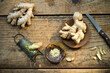 © Achim Sass/Westend61 - Kitchen knife, ginger roots and old grater lying on wooden surface