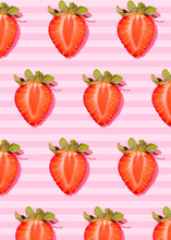 Pattern Of Rows Of Fresh Halved Strawberries Lying Against Pink Striped Background