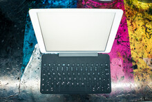 Digital Tablet With Keyboard On Rough Table In Factory