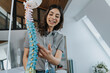 © Mareen Fischinger/Westend61 - Smiling female trainer explaining spine model in classroom