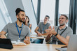 © Mareen Fischinger/Westend61 - Male trainee looking at smiling colleague clapping while sitting on bench in training class