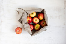 Apples Collected In Sack On White Textured Background