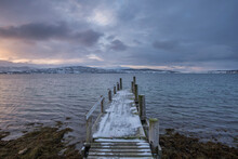 Norway, Tromso, Old Wooden Jetty At Fjord 