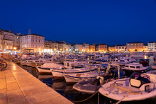 Croatia, Istria County, Rovinj, Motorboats Moored In Old Town Harbor At Night