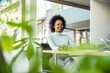 © Uwe Umstatter/Westend61 - Smiling businesswoman using computer at office