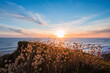 © Valentin Weinhaupl/Westend61 - Sun setting over Mahia Peninsula with clear line of horizon over Pacific Ocean in background