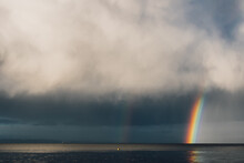 Gray Clouds With Rainbow Over The Sea Ocean 