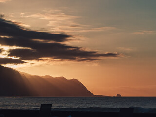 Sticker - Beautiful view of a sea with hills under a cloudy sky at sunset