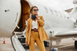 © Ivan - Business woman stand near private airplane jet