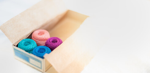 Wall Mural - The multicolor embroidery thread roll using in the garment industry put on the classic paper box