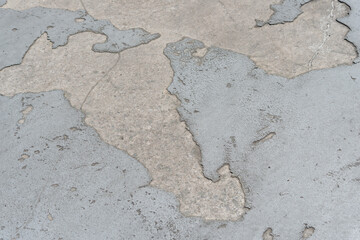 chipped concrete pavement background with areas of gray paint (or anti-slip coating)