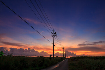 A magical and beautiful dusk cloud upon a country road with many telephone poles