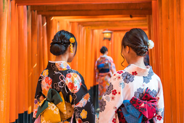 Wall Mural - Women in traditional japanese kimonos  at Fushimi Inari Shrine in Kyoto, Japan